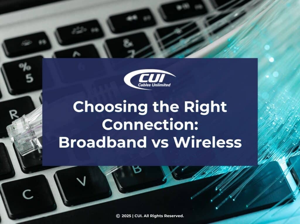 Featured: Close-Up Of Keyboard With Network Cables Plugged Into Port- Choosing The Right Connection: Broadband Vs. Wireless.